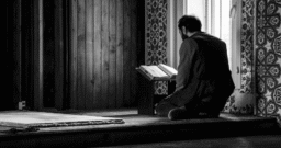 The Holy Qur’an resting on a wooden rehal, symbolizing daily spiritual reflection and closeness to Allah.