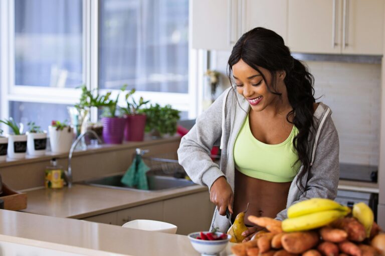 .A woman cooking a healthy meal in the kitchen as part of a balanced lifestyle routine