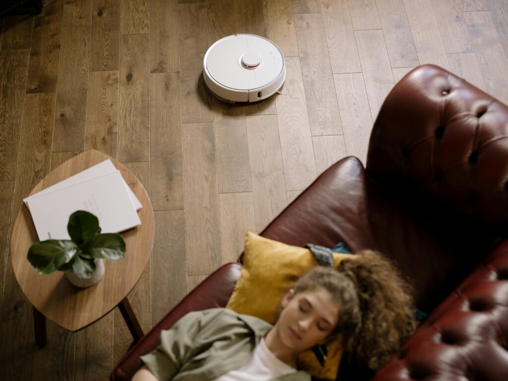 A modern minimalist living room with smart home technology, warm neutral tones, and clutter-free design in 2026