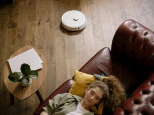 A modern minimalist living room with smart home technology, warm neutral tones, and clutter-free design in 2026