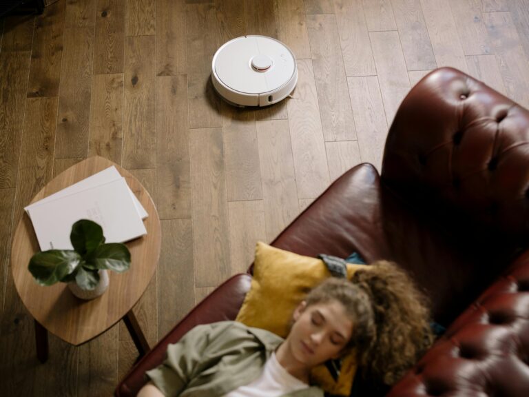A modern minimalist living room with smart home technology, warm neutral tones, and clutter-free design in 2026