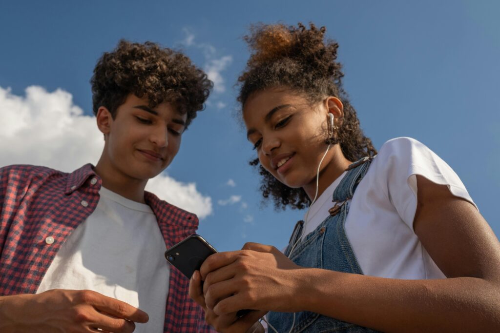 teenager girl and boy using a mobile