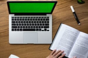 Keyword research checklist open on a laptop beside a fashion notebook