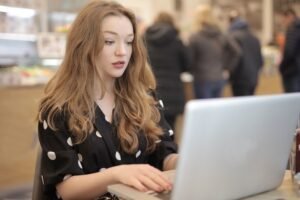 Person reading helpful blog articles on a laptop at a bright desk